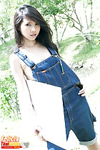 Wearing dungarees holding canvas