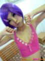 Wearing pink crop top purple hair arms raised small breasts