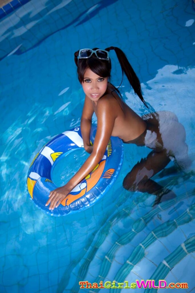 Kumlai nude in swimming pool hair in pigtails holding rubber ring