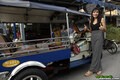 Standing beside tuktuk giving thumbs up