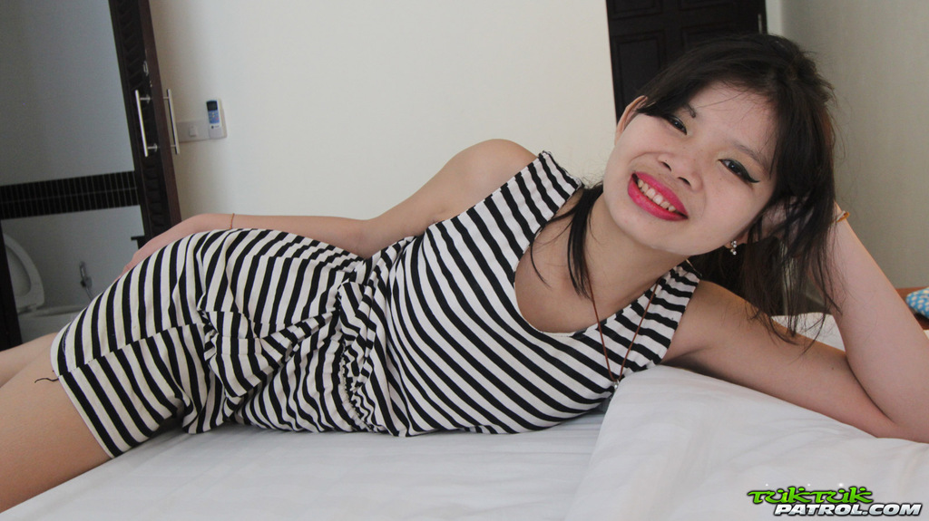 Nana lying on bed wearing striped dress